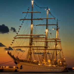 Der historische Dreimaster Mare Frisium bei Sonnenuntergang beleuchtet im Hamburger Hafen liegend